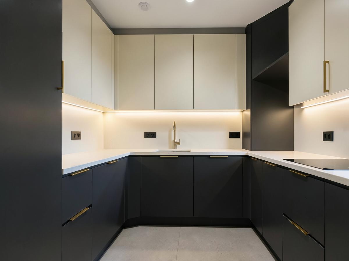 Modular kitchen interior with charcoal and cream cabinets in Hyderabad home